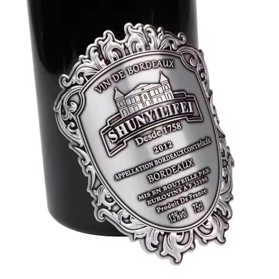 Custom embossed aluminum wine label with adhesive backing